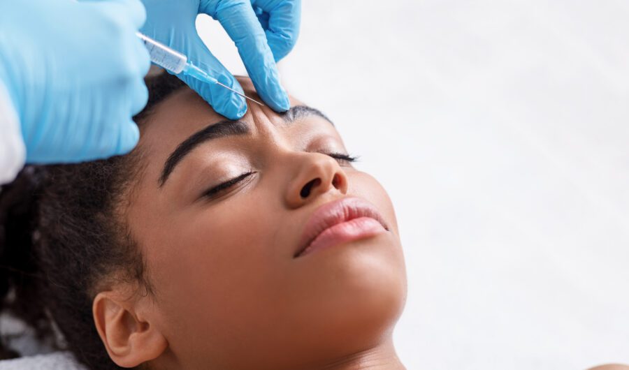 girl getting a botox injection between her eyebrows