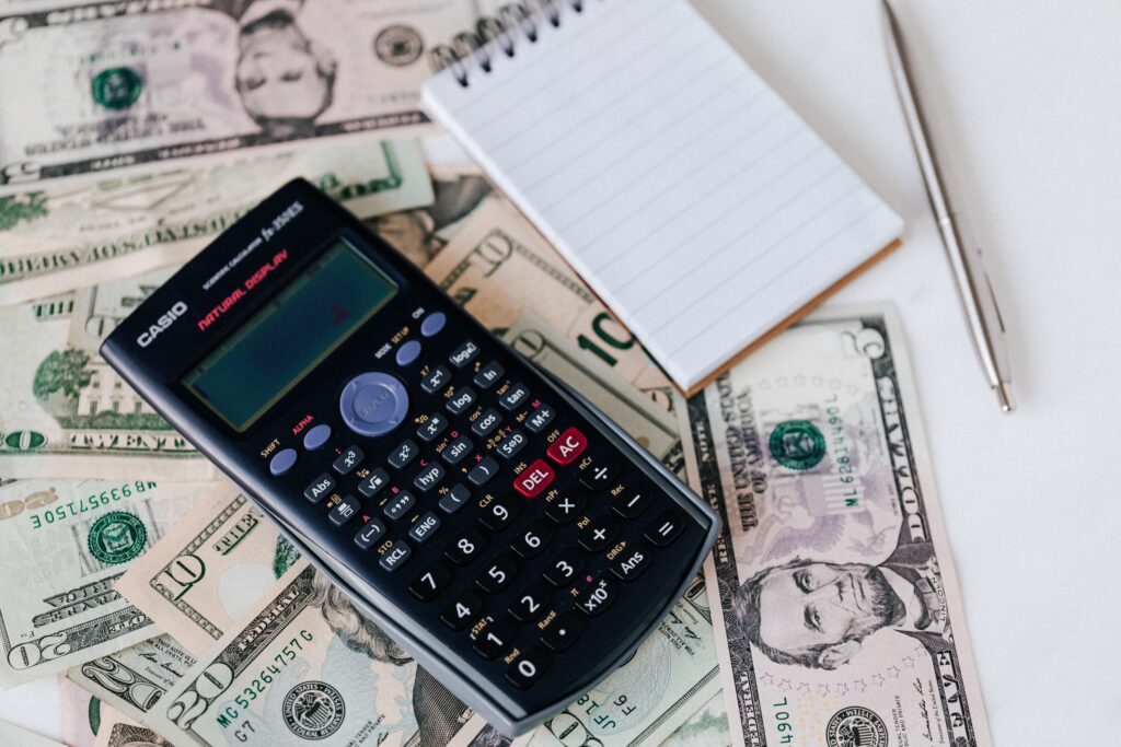 Calculator and notepad on top of money for Botox treatment