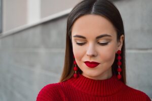 woman with brown hair wearing red lipstick after having crooked lips fixed