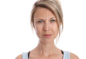 Lines dissecting a woman's face showing asymmetry